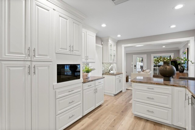 45 Adalia Ave, Tampa, FL 33606 - kitchen featuring recessed lighting, white cabinetry, dark stone countertops, light wood-type flooring, and glass insert cabinets