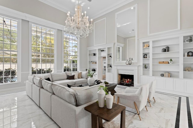 45 Adalia Ave, Tampa, FL 33606 - living area featuring light marble finish flooring, built in features, crown molding, a premium fireplace, and a chandelier