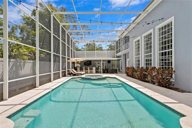 45 Adalia Ave, Tampa, FL 33606 - view of pool featuring a patio, a pool with connected hot tub, glass enclosure, and an outdoor hangout area