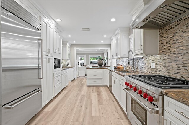 45 Adalia Ave, Tampa, FL 33606 - kitchen with high quality appliances, extractor fan, a sink, white cabinetry, and recessed lighting