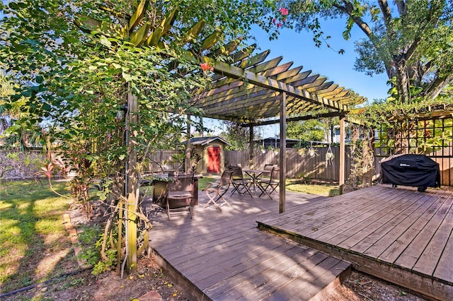 wooden deck featuring a pergola and a grill