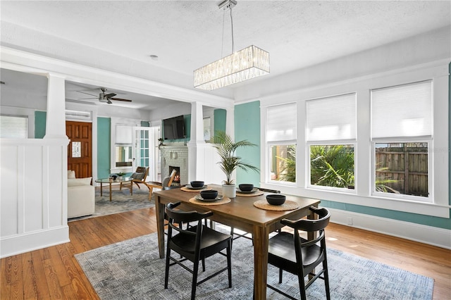 interior space featuring a brick fireplace and ceiling fan