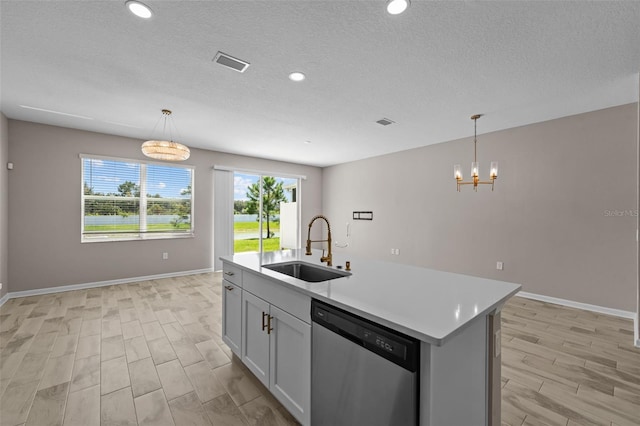 kitchen featuring a kitchen island with sink, dishwasher, pendant lighting, and sink