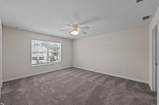 empty room with ceiling fan, carpet flooring, and a textured ceiling