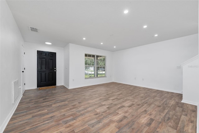 unfurnished living room featuring dark hardwood / wood-style floors