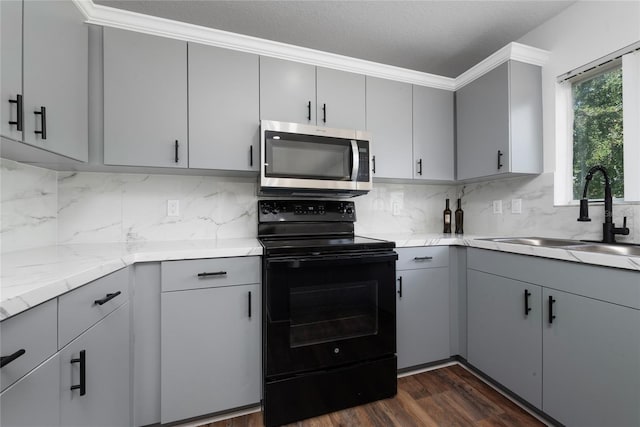 kitchen with black / electric stove, sink, and gray cabinets