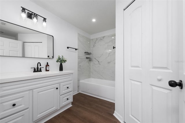 bathroom featuring tiled shower / bath combo, vanity, and hardwood / wood-style flooring