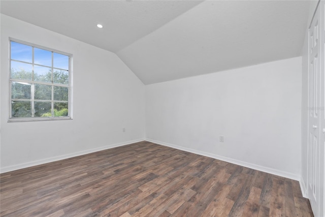 bonus room featuring lofted ceiling and dark wood-type flooring