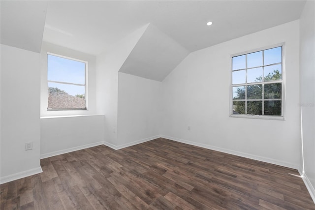 bonus room featuring lofted ceiling and dark hardwood / wood-style floors