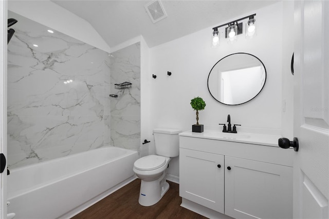 full bathroom with vanity, hardwood / wood-style flooring, tiled shower / bath combo, and toilet