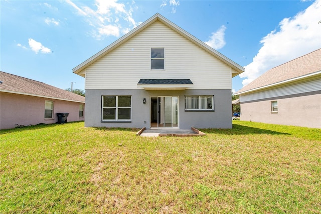 rear view of house with a yard and a patio