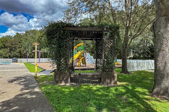 view of home's community featuring a lawn and a playground