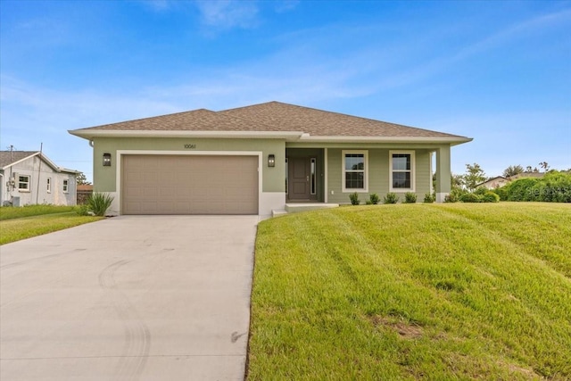 10061 Gulfstream Blvd, Englewood, FL 34224 - ranch-style house featuring an attached garage, driveway, a front lawn, and stucco siding