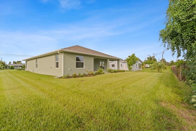 view of side of home with a lawn