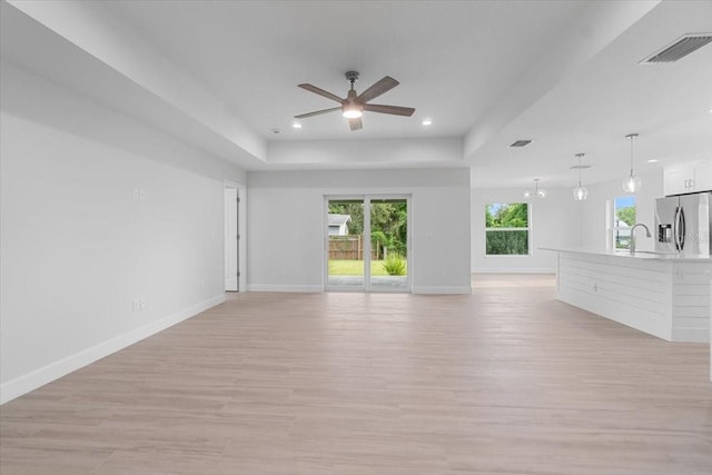 10061 Gulfstream Blvd, Englewood, FL 34224 - unfurnished living room featuring a ceiling fan, light wood finished floors, recessed lighting, baseboards, and a sink
