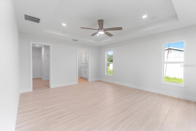 10061 Gulfstream Blvd, Englewood, FL 34224 - unfurnished bedroom featuring a raised ceiling, a spacious closet, light wood finished floors, baseboards, and recessed lighting