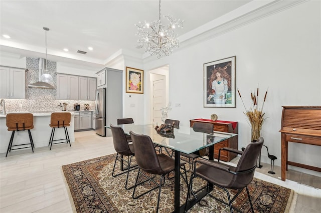 dining space featuring an inviting chandelier and crown molding