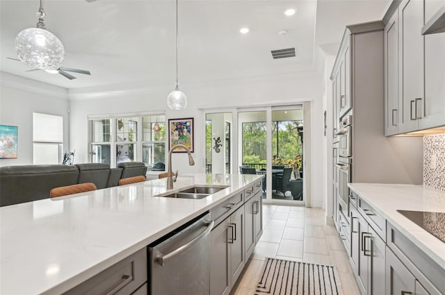 kitchen featuring pendant lighting, gray cabinets, sink, stainless steel appliances, and ceiling fan