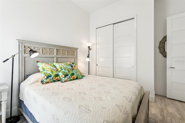 bedroom with a closet and hardwood / wood-style flooring