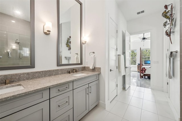 bathroom with ceiling fan, vanity, a shower, and tile patterned flooring