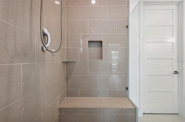 bathroom featuring a tile shower and tile patterned floors