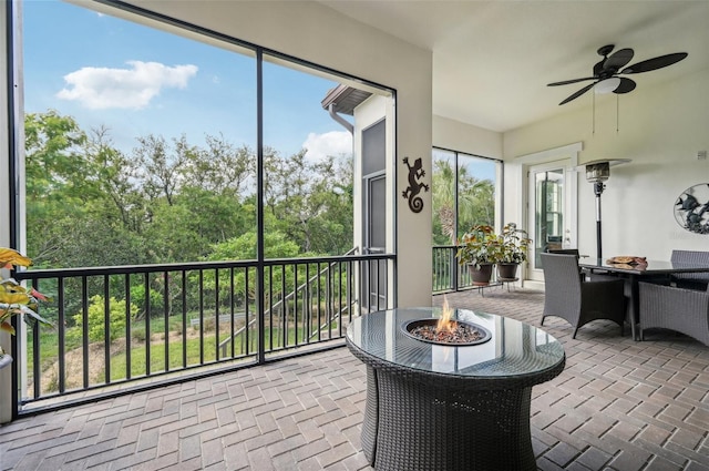 sunroom / solarium featuring ceiling fan and plenty of natural light