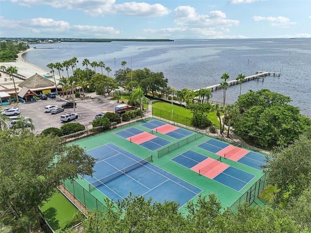 view of tennis court featuring a water view