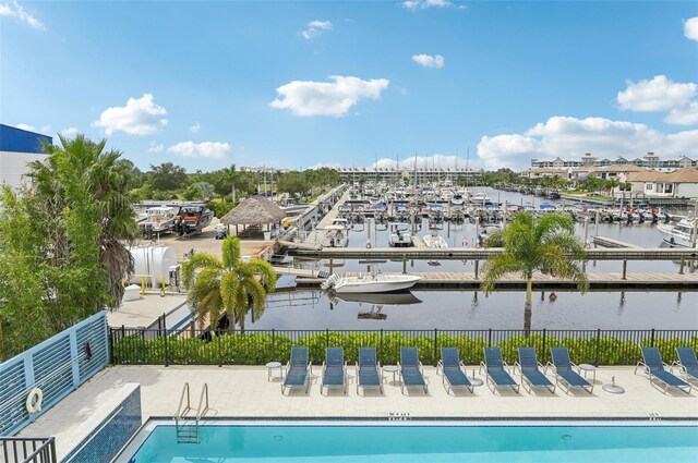 view of swimming pool featuring a water view