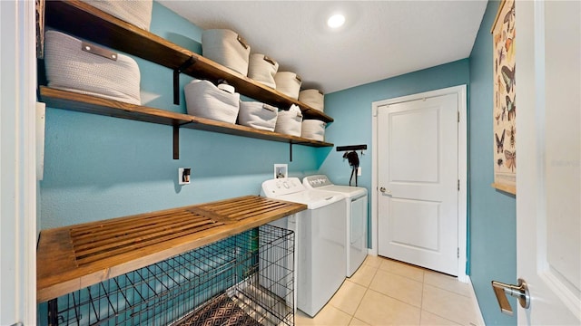 laundry room with laundry area, separate washer and dryer, light tile patterned floors, and baseboards