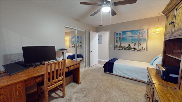 carpeted bedroom featuring a closet, electric panel, and ceiling fan