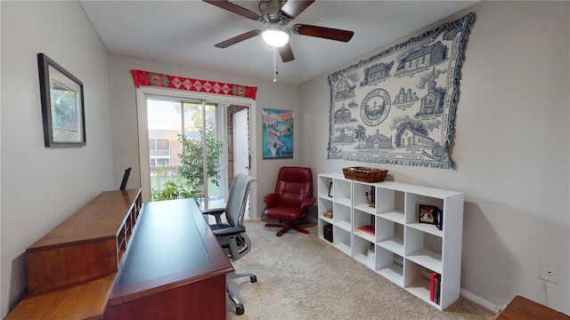 carpeted office space with ceiling fan