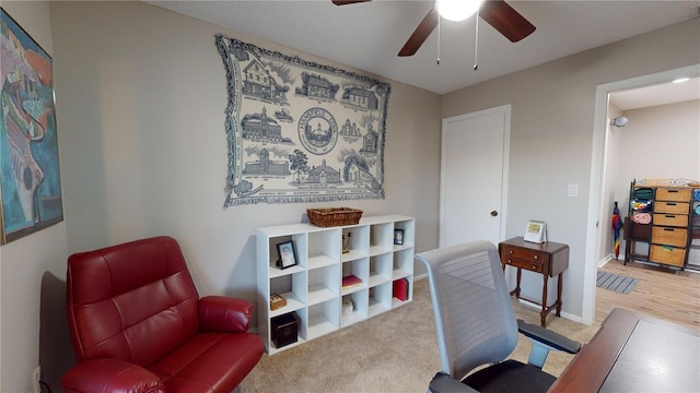 carpeted office with ceiling fan