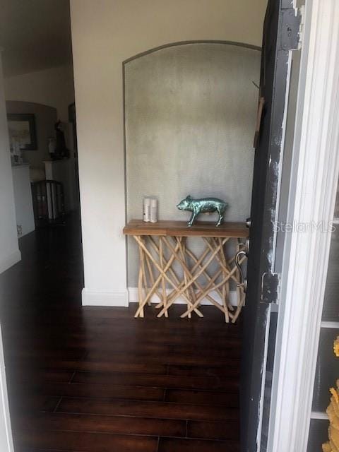 corridor with dark hardwood / wood-style floors