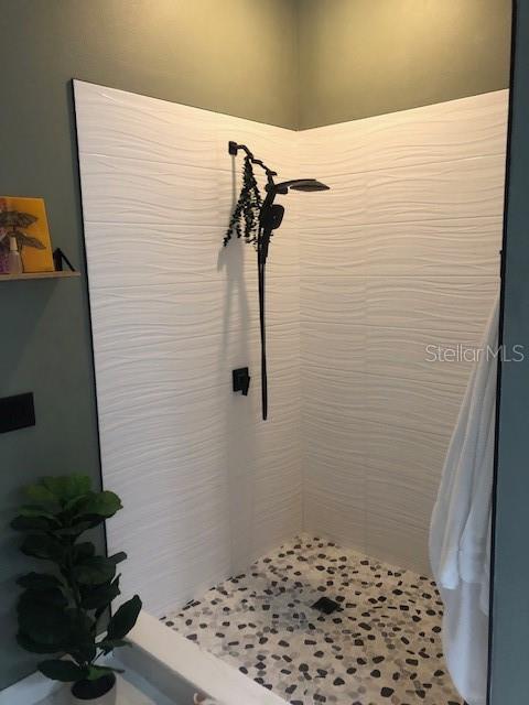 bathroom with tiled shower