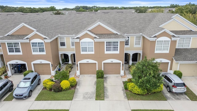 townhome / multi-family property featuring a garage