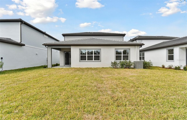 back of house with a yard and central AC unit