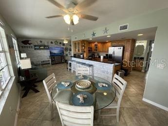 tiled dining room with ceiling fan