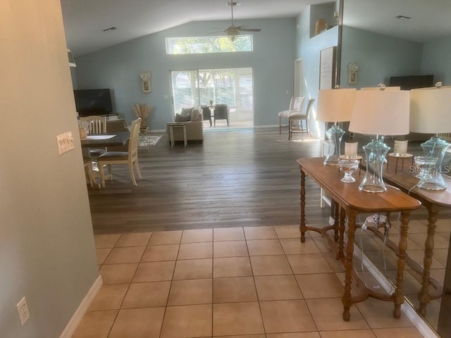 interior space with wood-type flooring, vaulted ceiling, and ceiling fan