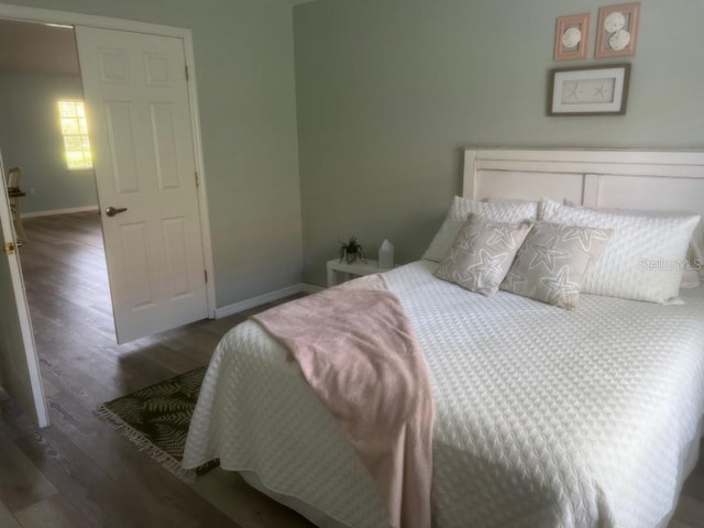 bedroom featuring a closet and dark wood-type flooring