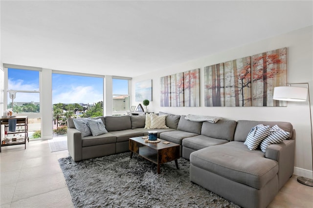 living room featuring a wall of windows and a healthy amount of sunlight