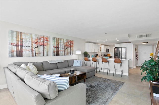 living room with plenty of natural light and sink