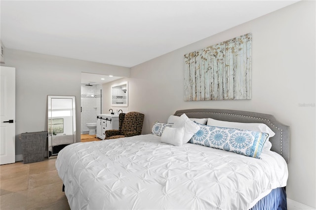 bedroom featuring tile patterned flooring, sink, and ensuite bath