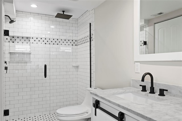 bathroom with vanity, walk in shower, and toilet