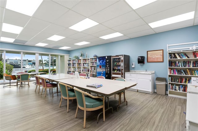 dining area featuring light hardwood / wood-style flooring and a paneled ceiling