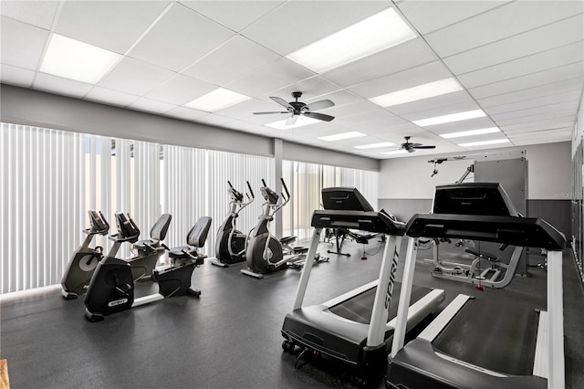 gym with a drop ceiling and ceiling fan