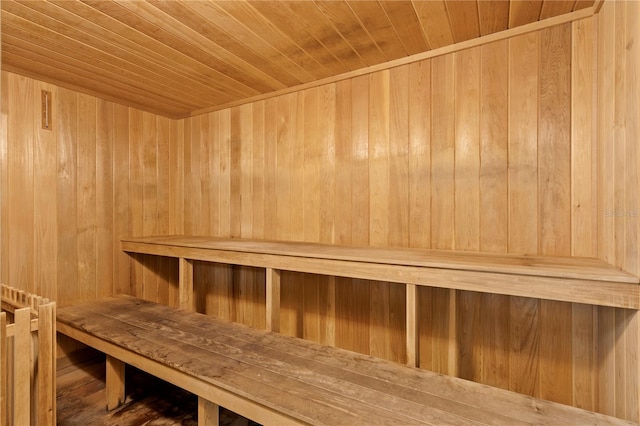 view of sauna / steam room featuring hardwood / wood-style flooring, wooden walls, and wood ceiling