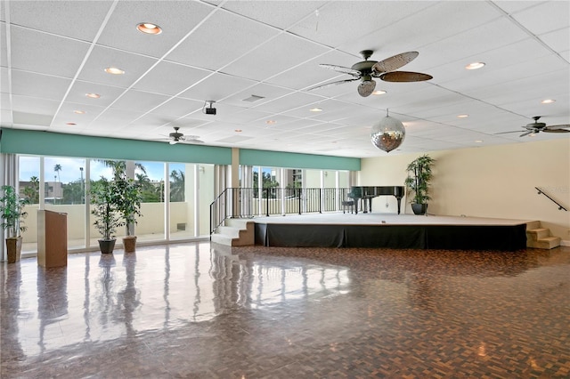 miscellaneous room featuring ceiling fan and a paneled ceiling