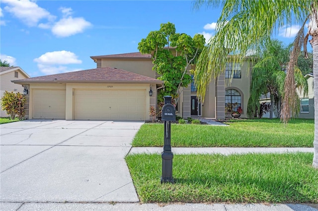 view of front of home featuring a garage and a front lawn