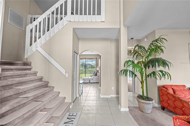 tiled entrance foyer with a textured ceiling