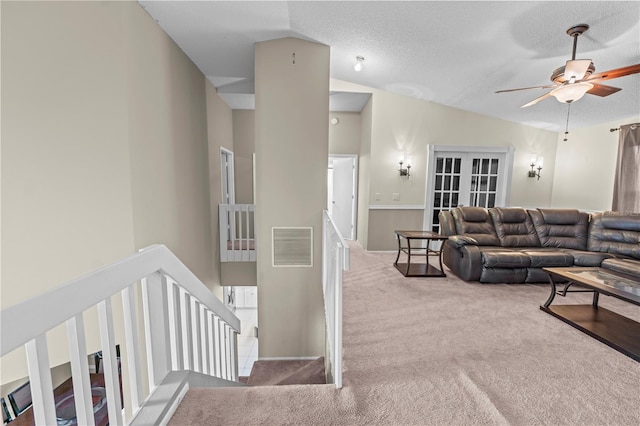 living room featuring ceiling fan, a textured ceiling, carpet flooring, and high vaulted ceiling